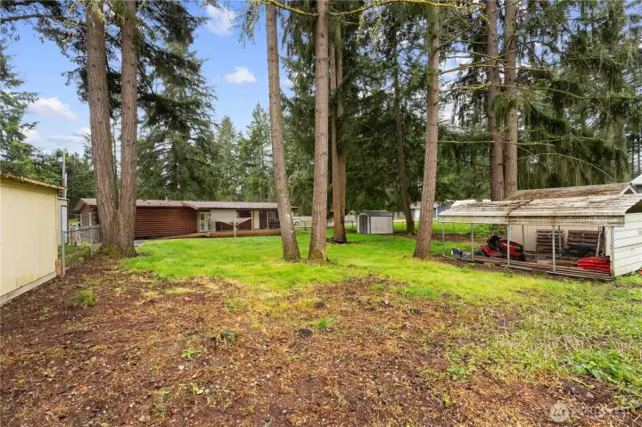 BACKYARD: Notice there are 2 Garden Sheds along with a Carport for Mower Storage.