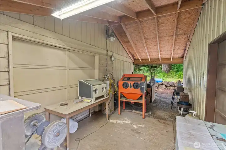 BREEZEWAY between the 2-Car Garage (on right) and the 2-Car Shop (on left). Notice that the 2-Car Garage has a garage door on the back that allows a drive-thru to the 2-Car Shop. All items will be removed - Seller is in the process of packing and moving.