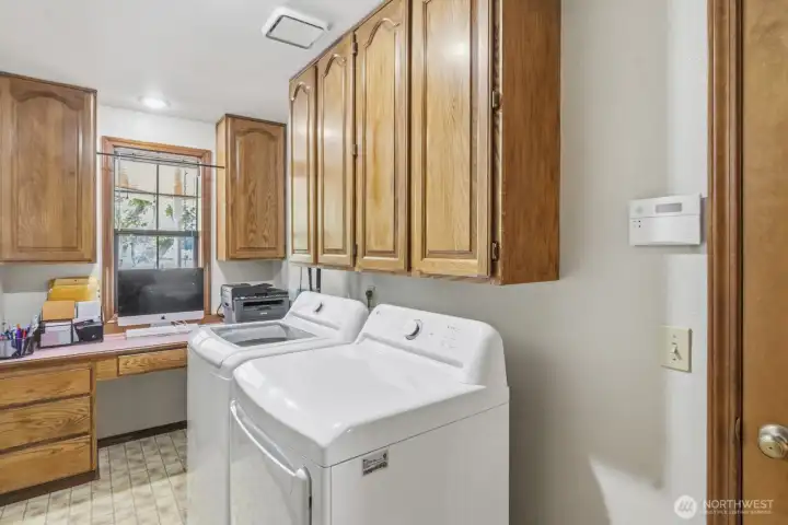 Laundry room with built-in desk Laundry room with built-in desk