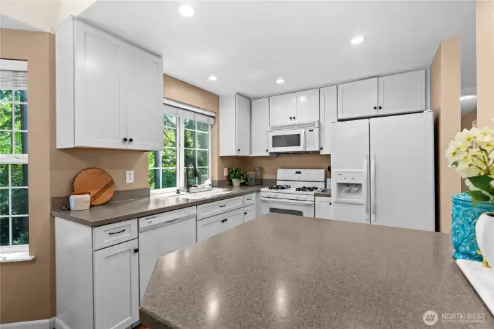 Blending style and functionality, this beautifully appointed kitchen features ample counter space, sleek cabinetry, and a layout that makes meal prep an absolute joy while staying connected to the rest of the home.