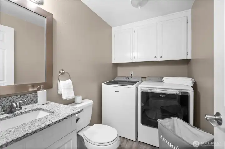 Efficiency at its finest! This versatile shared bathroom pulls double duty with an integrated laundry station, offering the ultimate everyday convenience without sacrificing space or style.