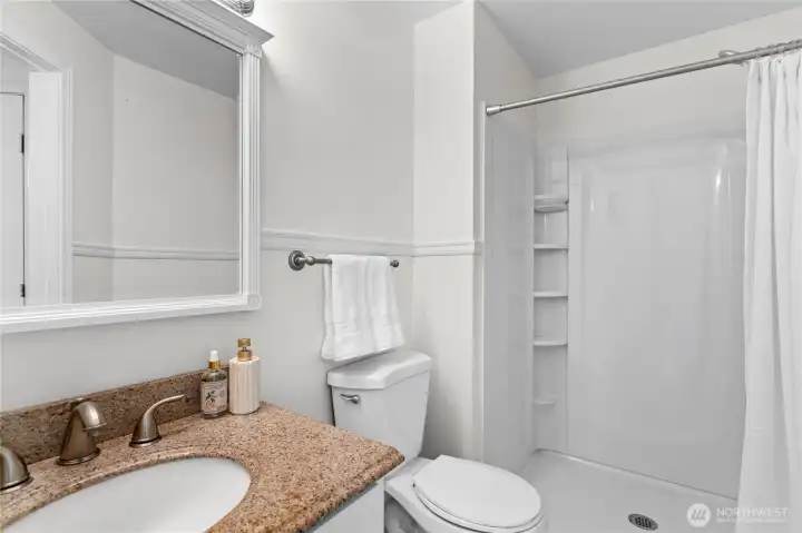 This private primary ensuite features a brand-new custom shower and sleek finishes, creating a crisp, clean sanctuary where you can wash the day away in style.