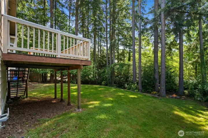 Welcome to your private park! This expansive, slightly sloping backyard is an outdoor paradise, featuring a built-in firepit for cozy evening storytelling, a fun playset for the kids, and miles of green grass with plenty of space left over for your creative gardening or landscaping ideas.