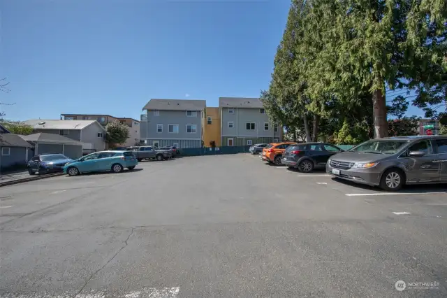 Assigned off street parking spot and guest spot in lot with level side entrance to the building.