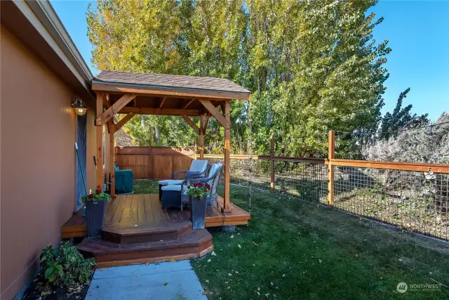 Secondary undercover deck with fenced in yard.