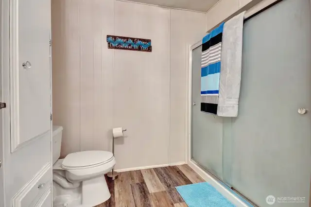 Large, no step seated shower for your convenience. Easy care laminate floors.