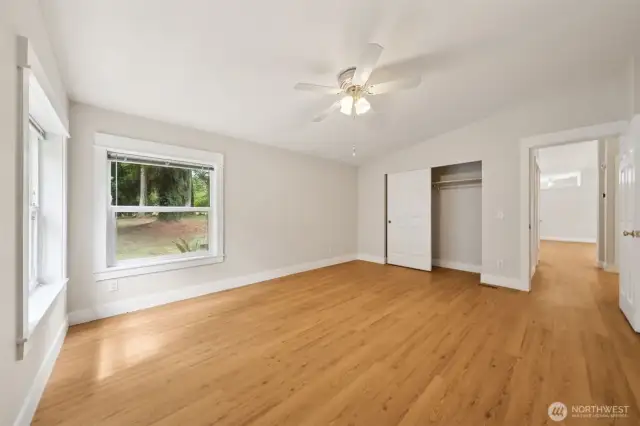 Another view of the Primary Bedroom. Notice that the wide baseboards and window edging flow throughout the home.