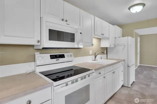 New stove and microwave in kitchen.  All appliances stay.