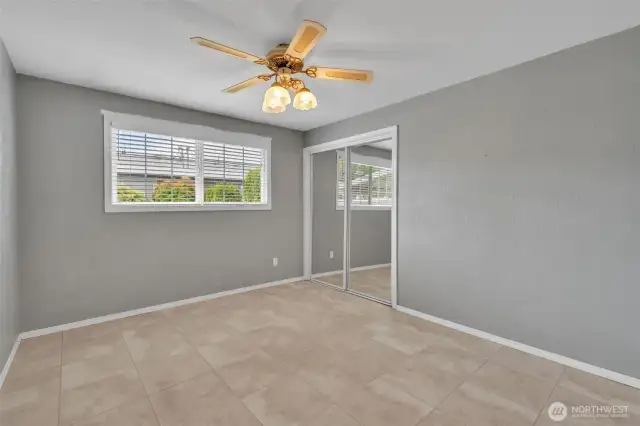 Primary bedroom with ceiling fan.