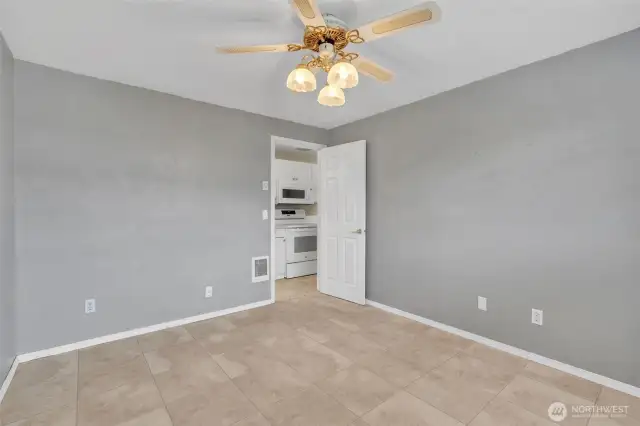 Primary bedroom with ceiling fan.