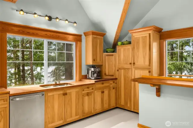 Soaring ceilings and abundant cabinet storage make this kitchen as functional as it is inviting.
