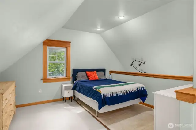A generous primary suite with sunlit skylights and office nook to work, create, or unwind.