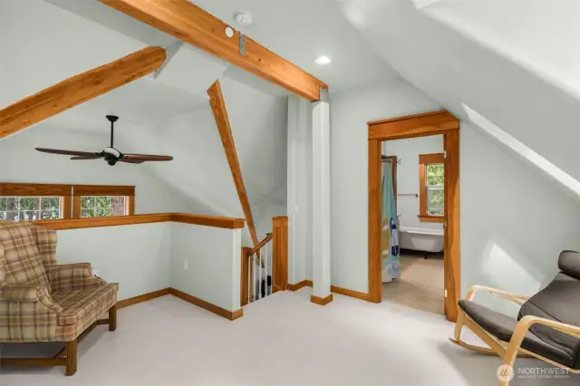 Elegant wood beams bring warmth and character to upper level.