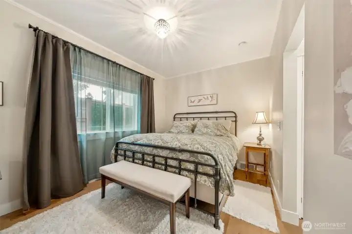 The primary suite offers LVP flooring that flows seamlessly throughout, accented by large baseboard trim and a touch of crown molding. Timeless lighting enhances the room’s charm, while the attached 3/4 bath adds convenience and privacy.
