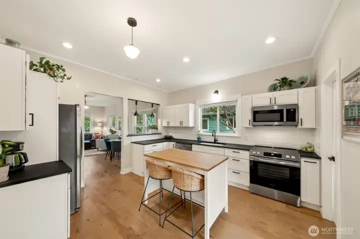 A bright, modern space ready for everyday living and entertaining- flows seamlessly from front living room thru dining area & into the kitchen.
