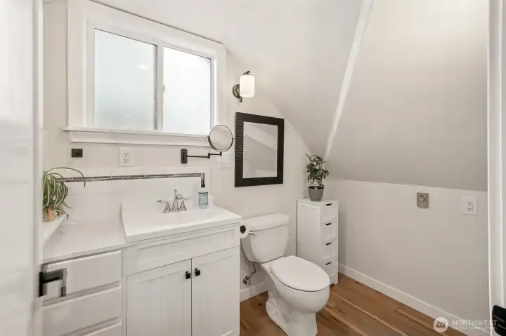 Upstairs is a bathroom with LVP flooring & bathtub.