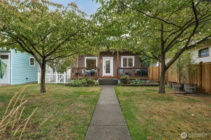 Nicely sized front yard adorned with mature cherry trees, offering curb appeal, shade, and a welcoming atmosphere.