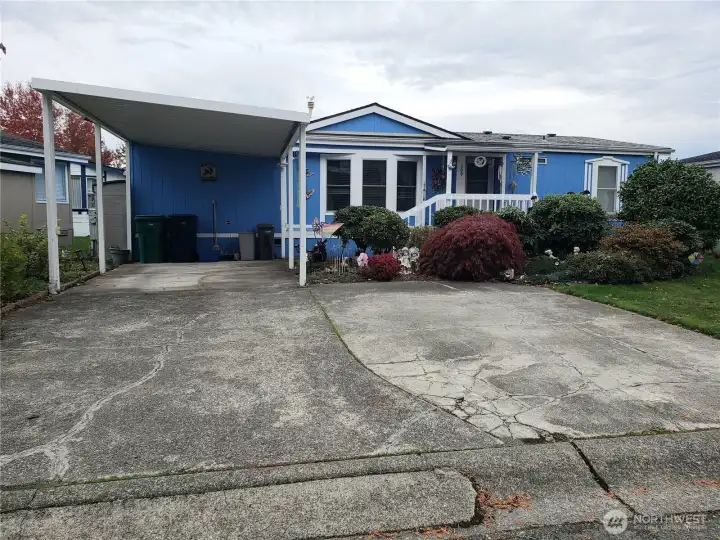 Great Picture of the Front of the Home Showing Carport and Parking Enough for 3 Vehicles.