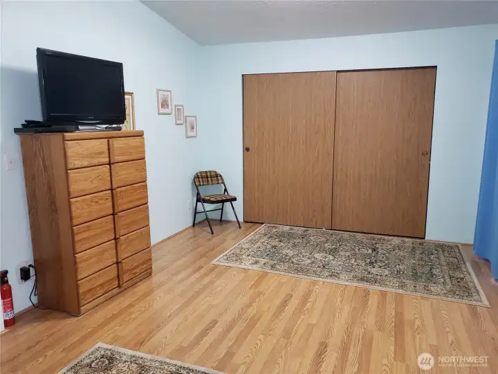 Another View of the Spacious Primary Master Bedroom with Cathedral Ceilings, Full Wall Closet and Laminate Flooring.