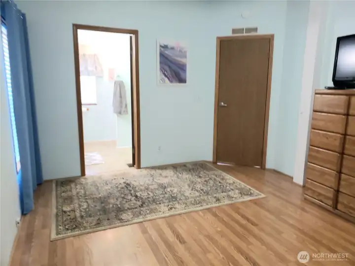 A Different View of the Spacious Primary Master Bedroom with Cathedral Ceilings, Full Wall Closet and Laminate Flooring showing the Primary Bathroom.