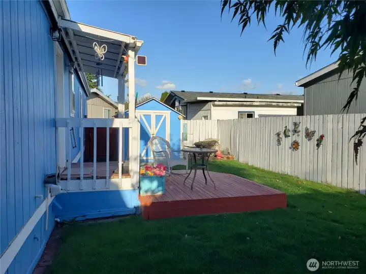 Opposite View of the Nice Size Pet Friendly Fully Fenced Backyard Showing Covered Deck and Larger Deck Below.