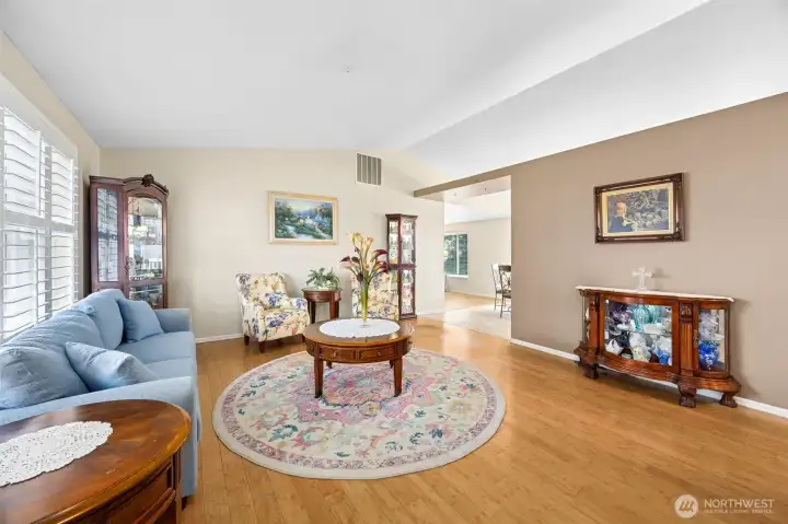 Front formal living area opens to the kitchen/dining area through the vaulted ceilings- making this floorplan feel open & bright.