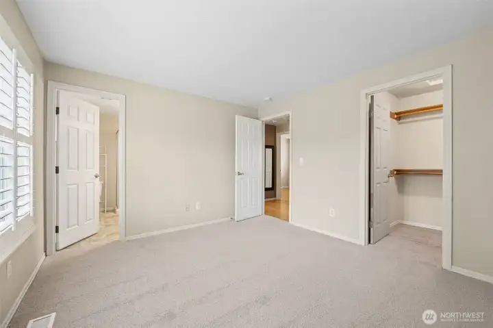 Primary Suite with walk-in closet & attached 3/4 bathroom.