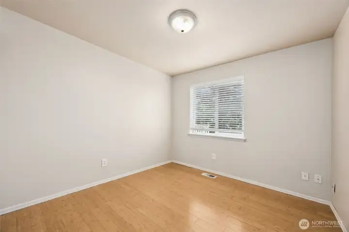 Bedroom #2 with the continued bamboo flooring & white trim work.