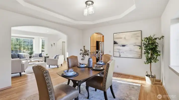 Enjoy an elegant formal dining room with a tray ceiling and open flow into the main living spaces.