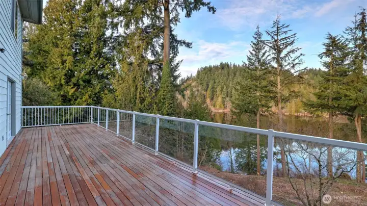 Enjoy peaceful mornings and evening sunsets from this spacious deck with serene water views.