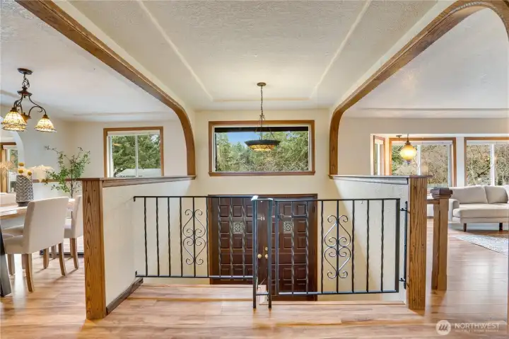 Beautiful woodwork, arches, wrought iron and swag light fixtures complete the vibe in this spacious home.