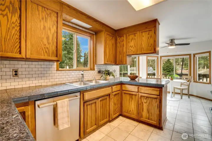 The kitchen includes upgraded appliances, granite tile counters and a sunny breakfast nook.