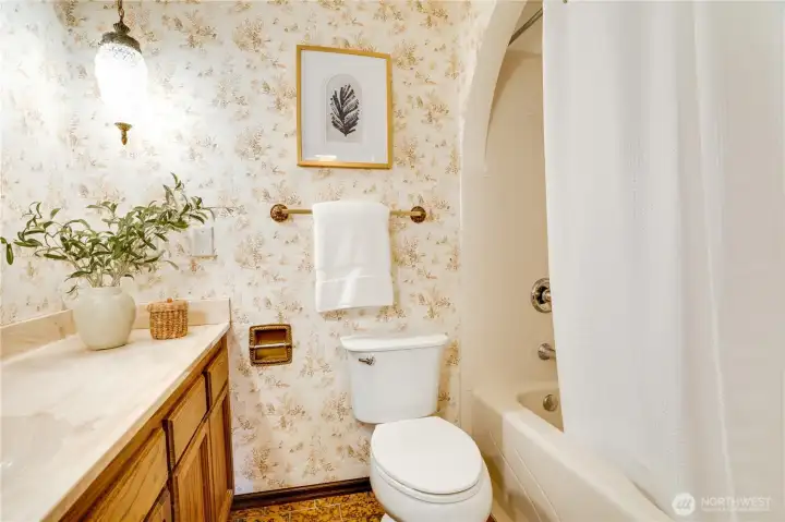 This hall bath has original light fixtures bringing a retro-style to this space.