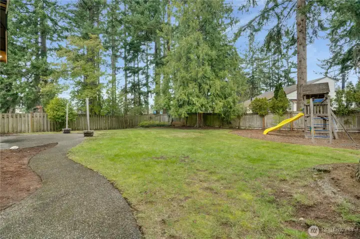 Frolic and play in this expansive fenced yard with aggregate patio, play set and plenty of room for fido or your fire pit conversation area.