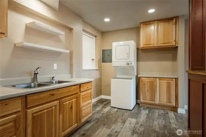 Lower level kitchen and laundry.  Door on left is a clean/dry storage area 4' tall under house