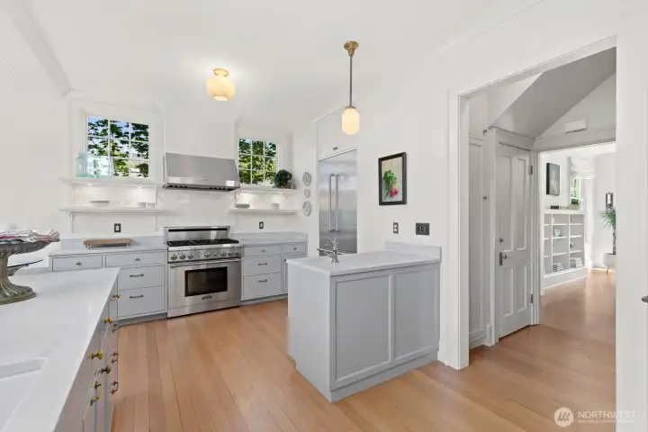This view looks from kitchen toward pantry area with door to basement and onto living room. This view looks from kitchen toward pantry area with door to basement and onto living room.