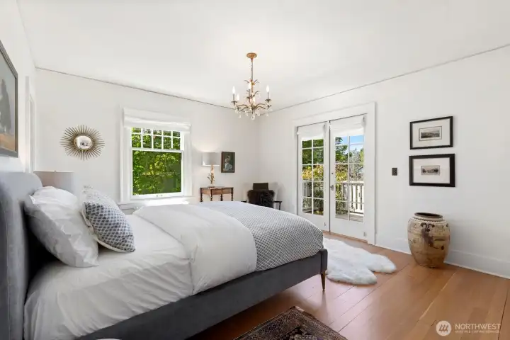 The primary bedroom with ensuite bath and walk-in closet enjoys its own private deck with flowering clematis spilling out over the railing. The primary bedroom with ensuite bath and walk-in closet enjoys its own private deck with flowering clematis spilling out over the railing.