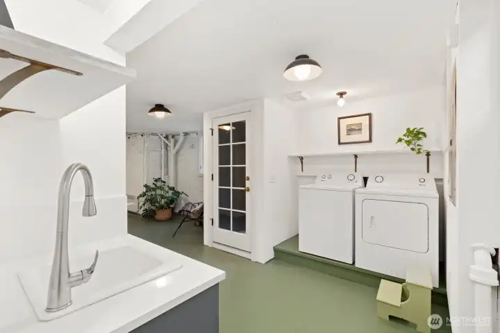 This view of the lower level shows the second laundry area and outside entrance. This view of the lower level shows the second laundry area and outside entrance.