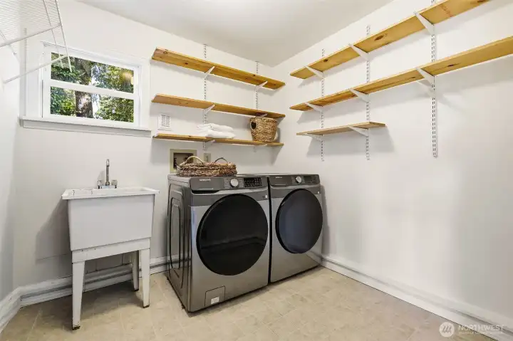 Main floor laundry with open shelving and added storage space