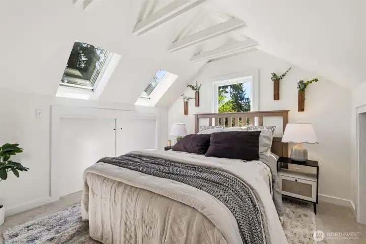 Upstairs bedroom with skylights and peaceful character