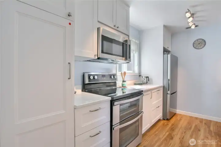 Kitchen remodeled in 2022. Deep drawers for pans, neutral color pallet, stone countertops, updated lighting, brushed nickel hardware, and stainless appliances. Kitchen remodeled in 2022. Deep drawers for pans, neutral color pallet, stone countertops, updated lighting, brushed nickel hardware, and stainless appliances.