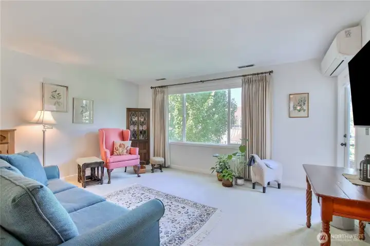 Living room with picture window and door to deck. Living room with picture window and door to deck.
