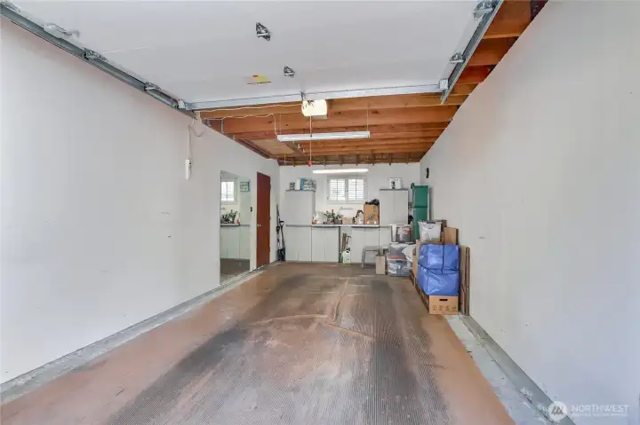 Deep single car garage with overhead storage and pull down stairs. Protective rubber floor mat. Deep single car garage with overhead storage and pull down stairs. Protective rubber floor mat.