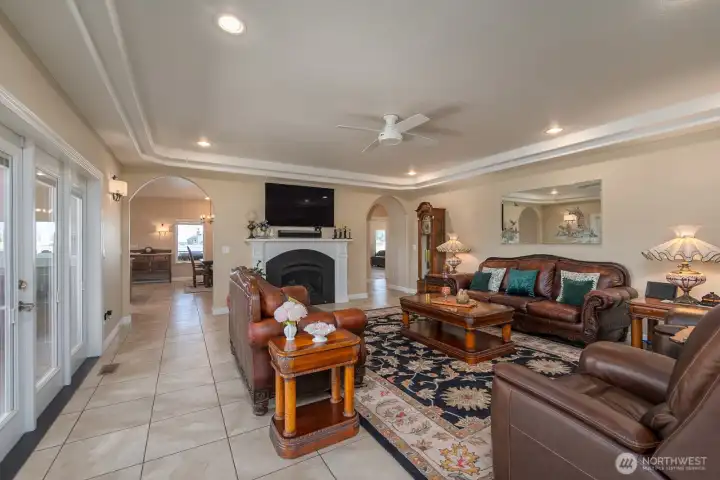 The Living Room with arched accesses to the Dining Room and Kitchen. The doors to the left access the private Hot Tub patio.