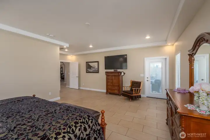 Primary Ensuite featuring non-slip tile and access to the back patio and pool.