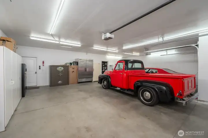 3-Car Garage with access to the extra room, currently used as a sewing room.