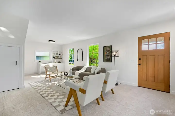 Living Room with stairs to 2nd floor and built in desk at far end of room Living Room with stairs to 2nd floor and built in desk at far end of room