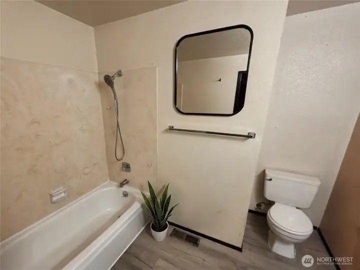The bathtub is on the upper level.