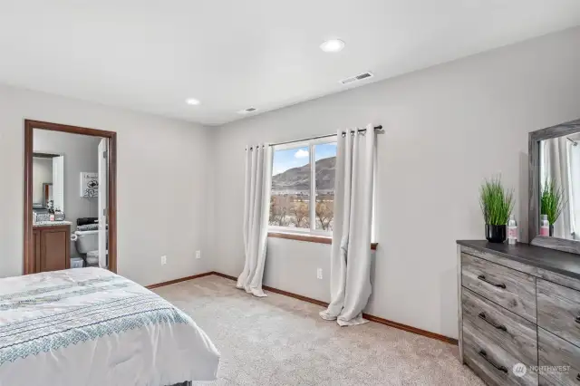 Large primary bedroom. Views of mountains, lake, golf course.