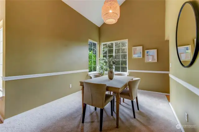 Formal Dining has large windows that overlook the backyard and is adjacent to the kitchen.